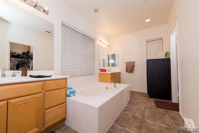 1892 Ribera Drive Oxnard, CA 93030 - Photo 32 of 34 a bathroom with a tub sink and mirror