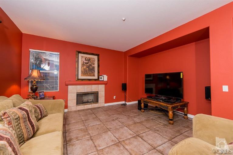 1892 Ribera Drive Oxnard, CA 93030 - Photo 9 of 34 a living room with furniture a fireplace and a flat screen tv