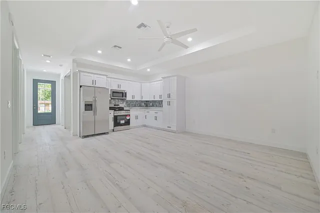a view of kitchen with refrigerator and window