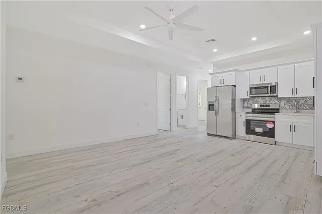 a view of kitchen with stainless steel appliances refrigerator and microwave