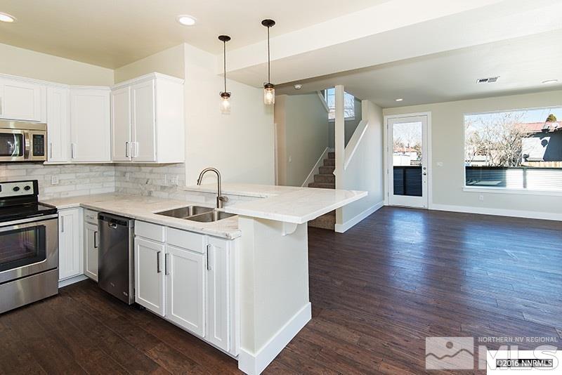 711 Roberts Street Reno, NV 89502 - Photo 1 of 13 a kitchen with a sink stove and wooden floor