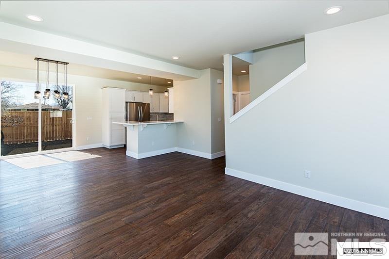 711 Roberts Street Reno, NV 89502 - Photo 4 of 13 an empty room with wooden floor and kitchen view