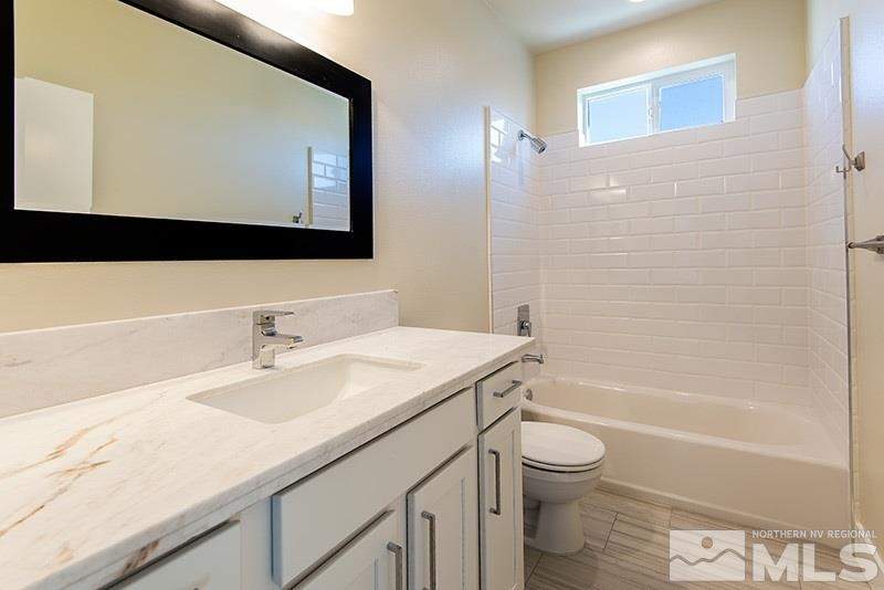 711 Roberts Street Reno, NV 89502 - Photo 6 of 13 a bathroom with a sink a toilet and a bathtub