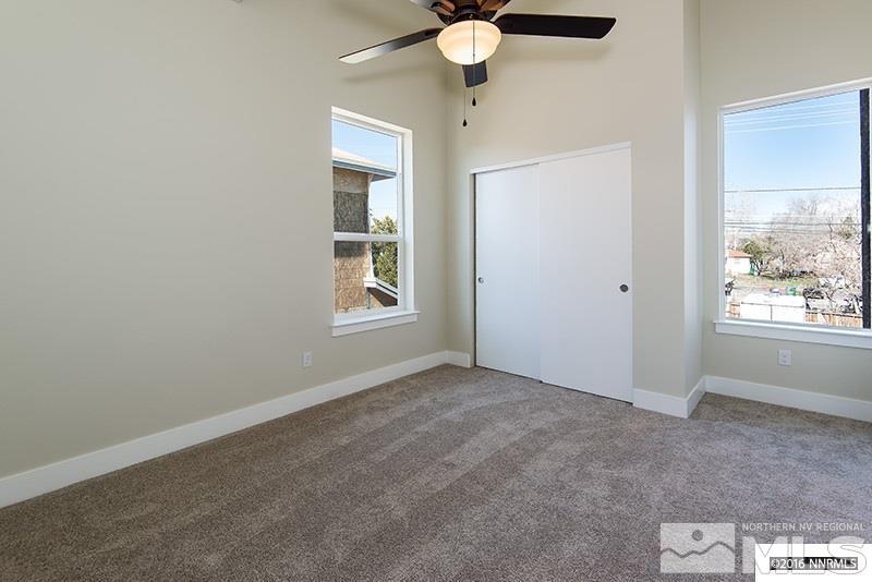 711 Roberts Street Reno, NV 89502 - Photo 8 of 13 an empty room with windows and fan
