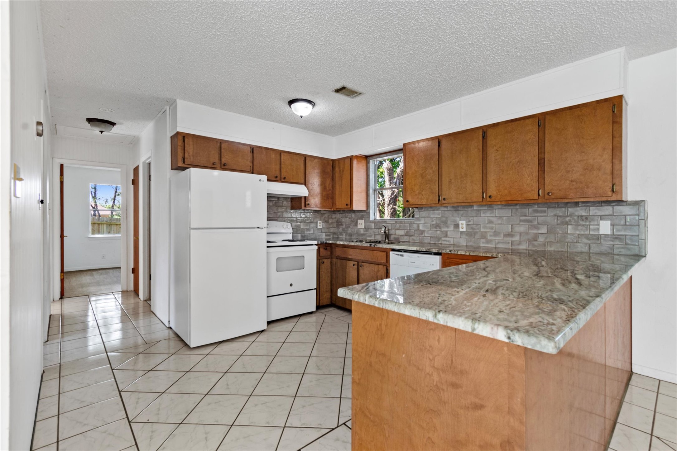6 El Sol Road Wimberley, TX 78676 - Photo 3 of 20 A well-appointed kitchen features ample cabinetry, durable tile flooring, and a convenient breakfast bar.
