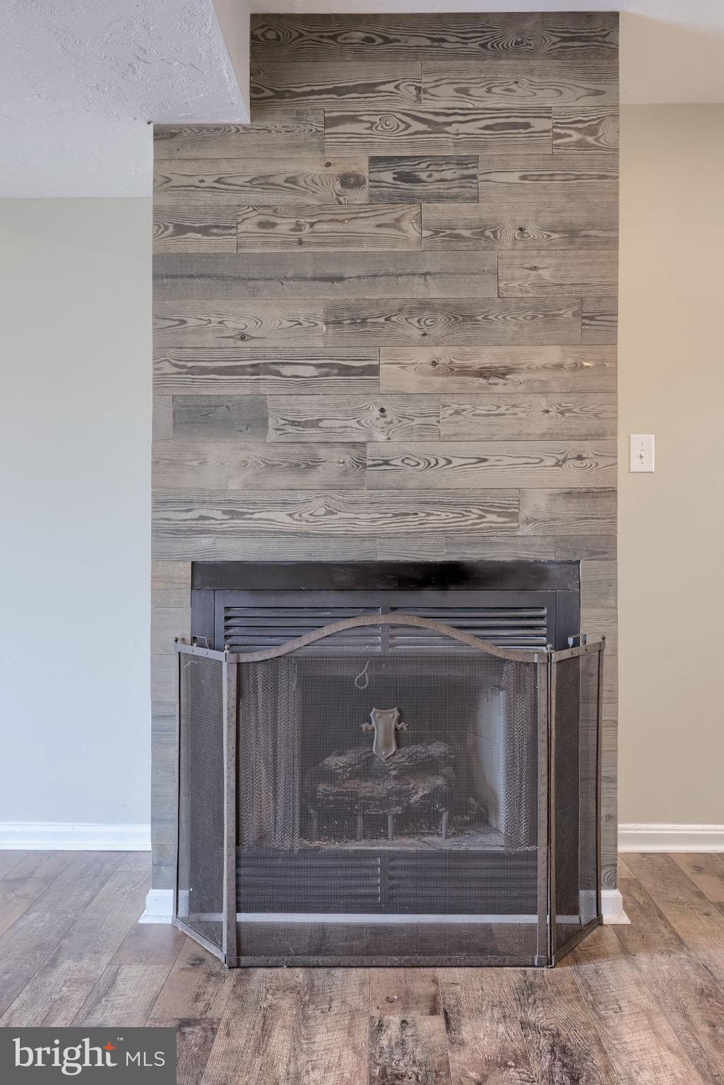 3333 Druck Valley Road York, PA 17406 - Photo 27 of 40 Cozy fireplace with rustic wood accents.