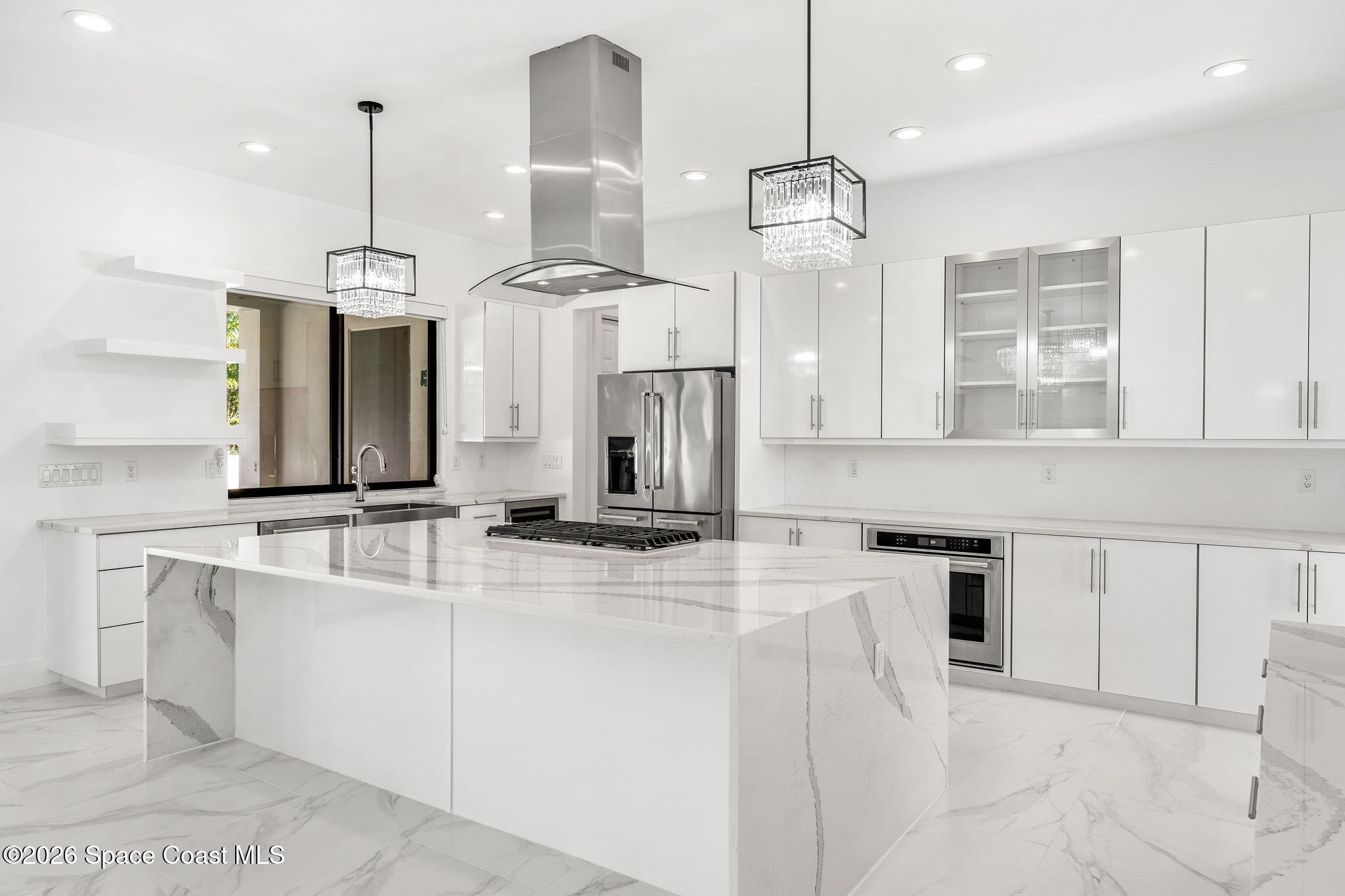 2355 North Riverside Drive Indialantic, FL 32903 - Photo 13 of 70 a kitchen with kitchen island white cabinets and refrigerator