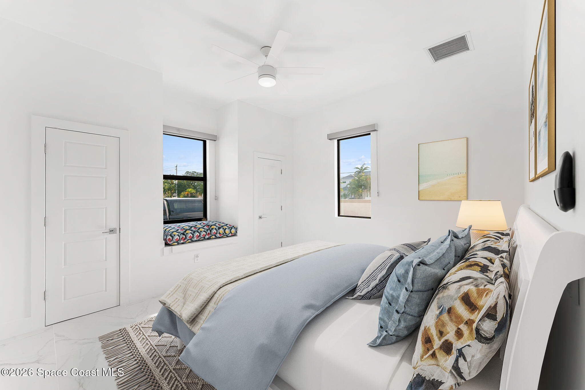 2355 North Riverside Drive Indialantic, FL 32903 - Photo 27 of 70 a bedroom with a bed and a painting on the wall