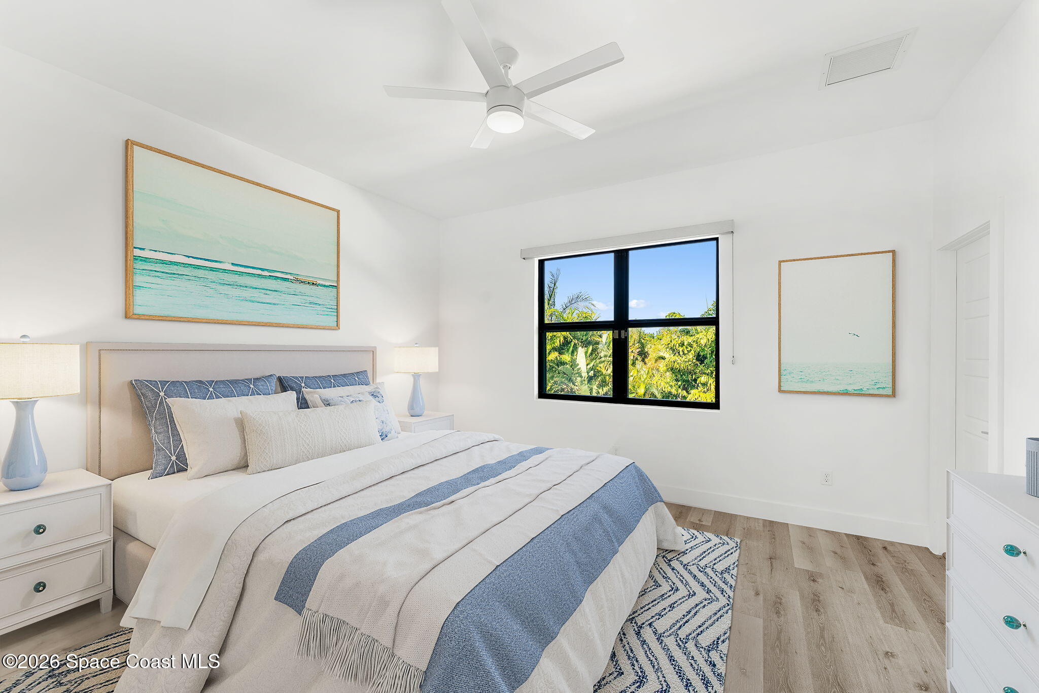 2355 North Riverside Drive Indialantic, FL 32903 - Photo 34 of 70 a bedroom with a bed and a painting on the wall