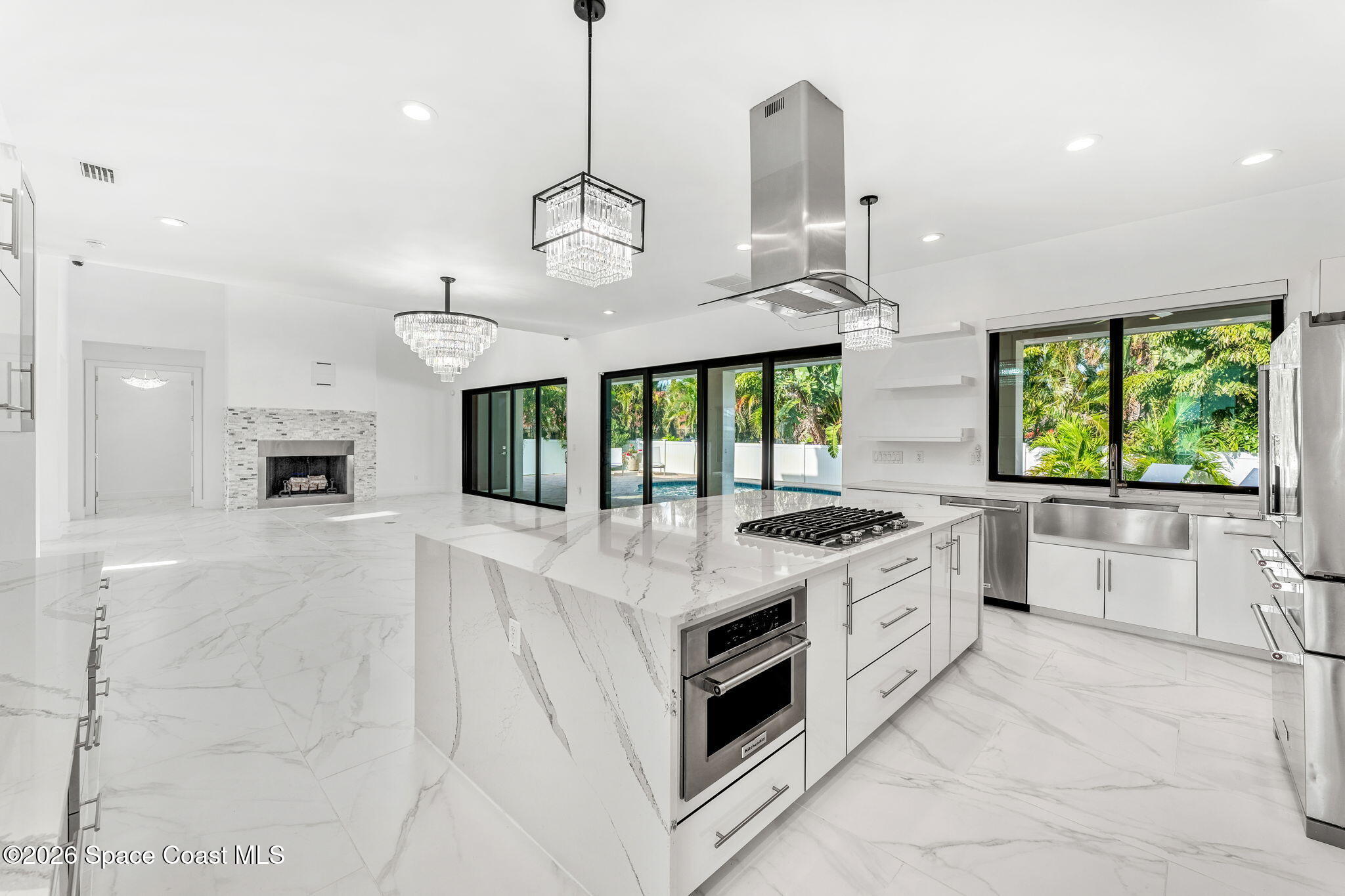 2355 North Riverside Drive Indialantic, FL 32903 - Photo 41 of 70 a large kitchen with stainless steel appliances granite countertop a stove oven and a large refrigerator with wooden floor