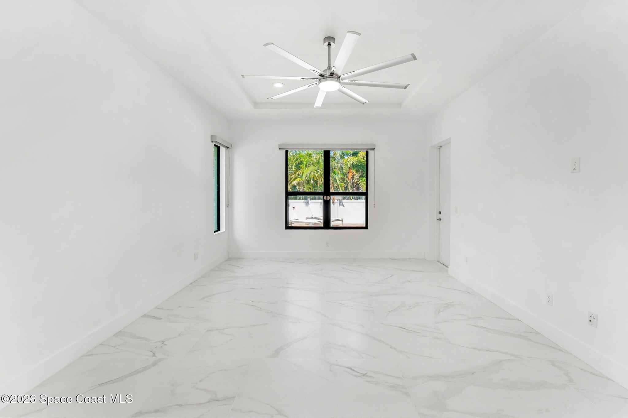 2355 North Riverside Drive Indialantic, FL 32903 - Photo 63 of 70 an empty room with windows and ceiling fan