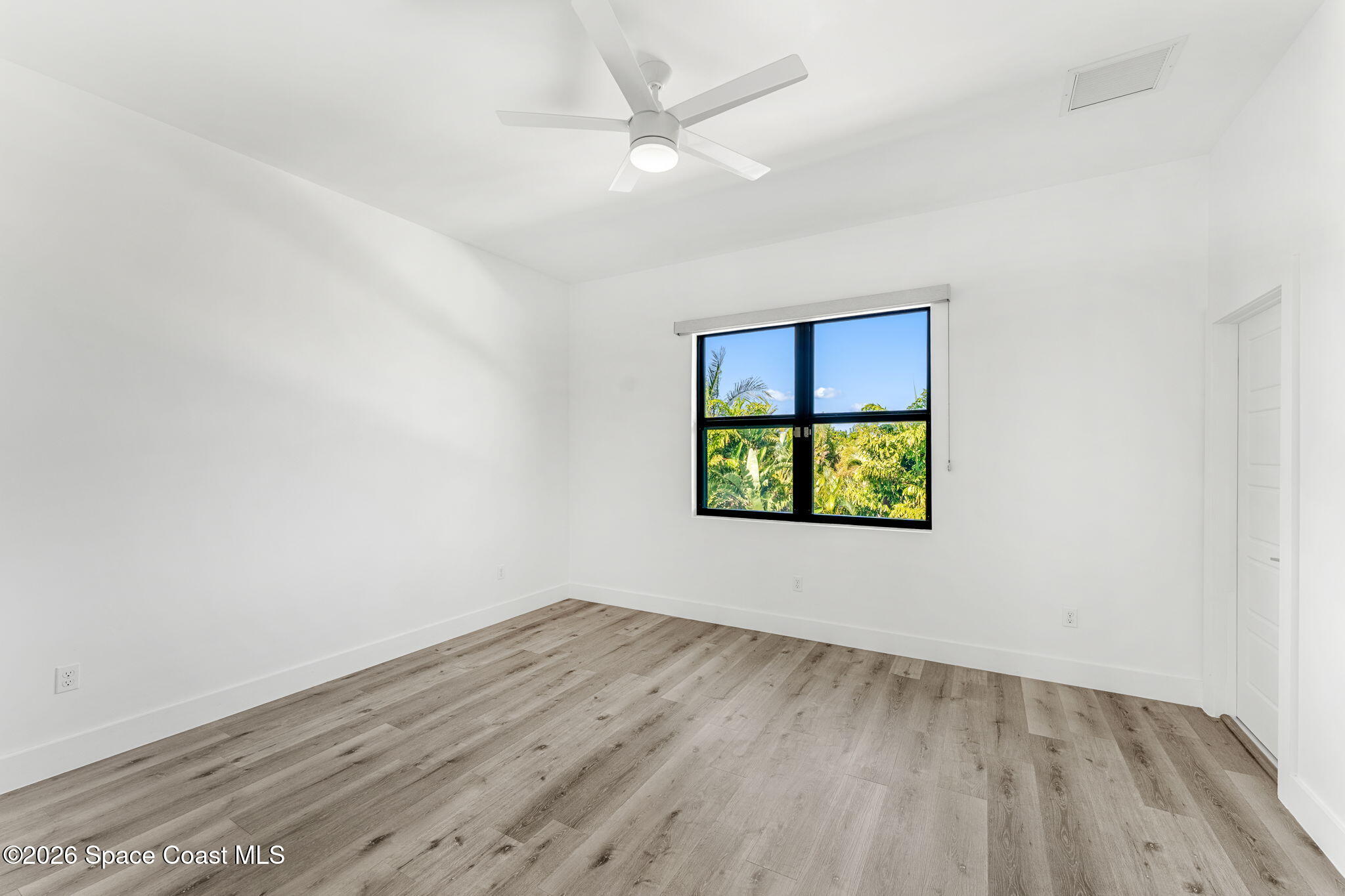 2355 North Riverside Drive Indialantic, FL 32903 - Photo 68 of 70 an empty room with wooden floor and windows