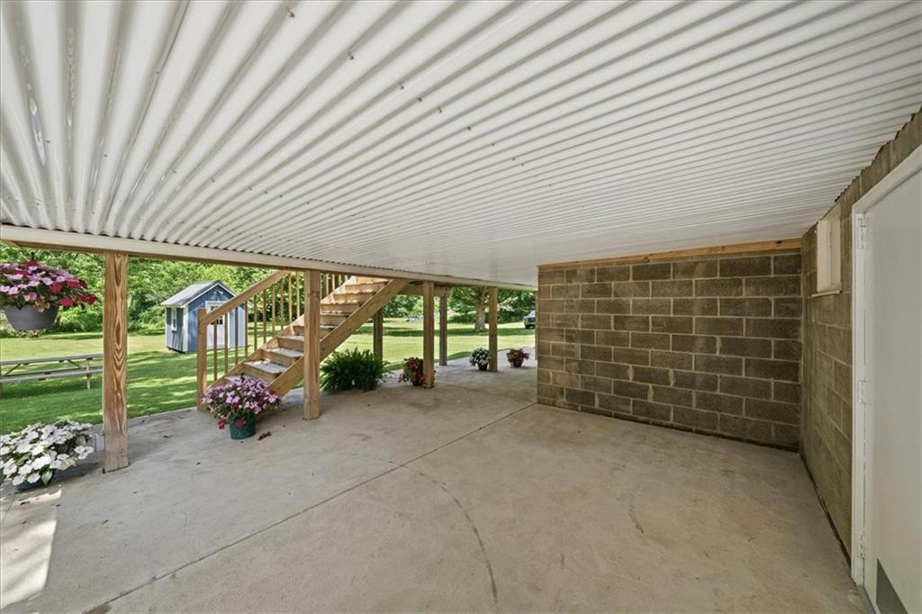 217 Country Club Road Washington, PA 15301 - Photo 35 of 50 Concrete patio with French-door access to the lower-level kitchen — seamless indoor-outdoor living on 27 private acres.