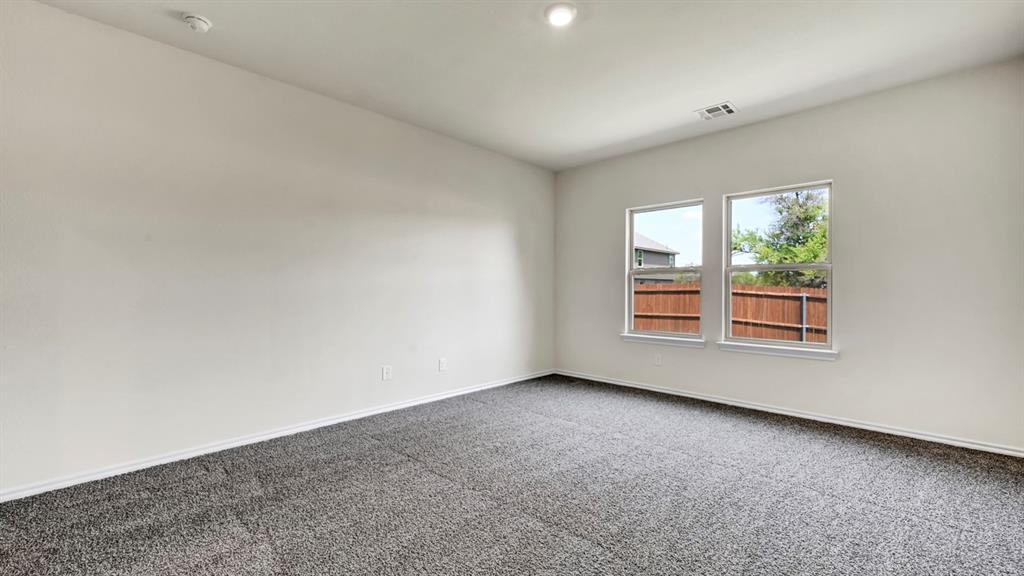 4012 Ripplewood Drive Lindale, TX 75771 - Photo 8 of 37 Spacious room featuring neutral carpeting, white baseboards, and two double-hung windows