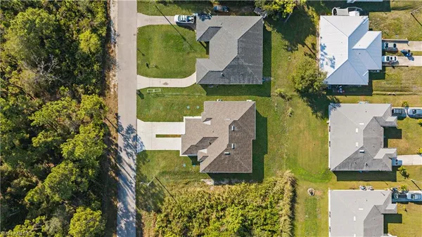 an aerial view of a house with a yard