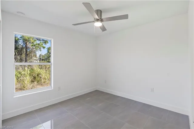 a bathroom with a granite countertop tub sink toilet and mirror