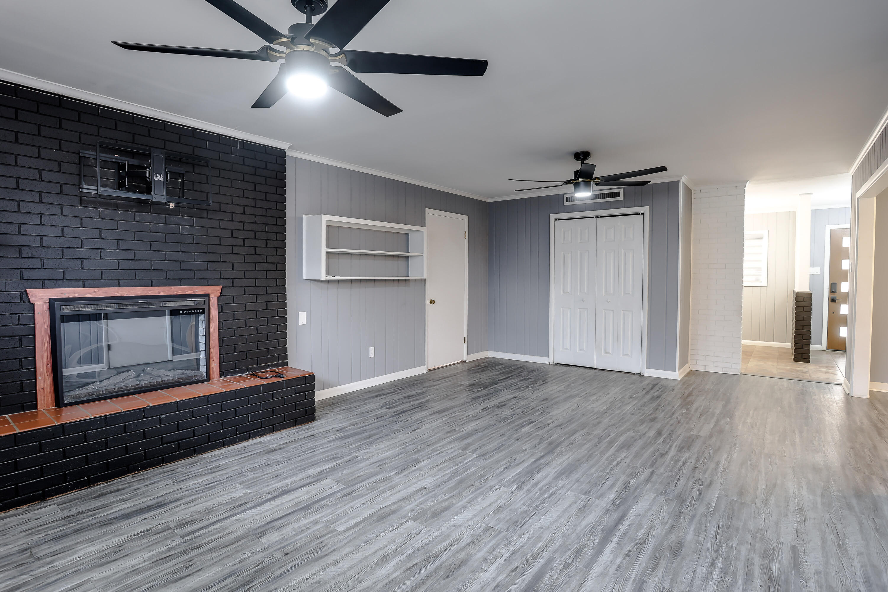 3615 47th Street Lubbock, TX 79413 - Photo 11 of 36 a living room with wooden floor and a fireplace