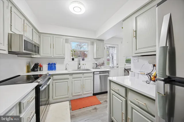 a kitchen with a sink cabinets and window