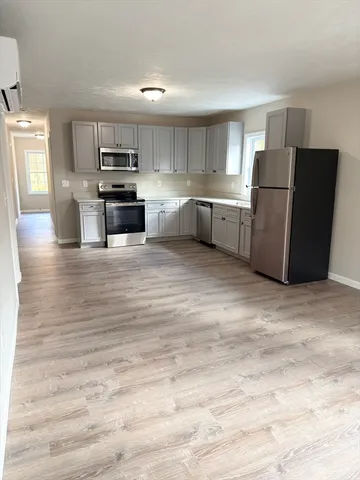 a kitchen with stainless steel appliances granite countertop a refrigerator and a stove top oven