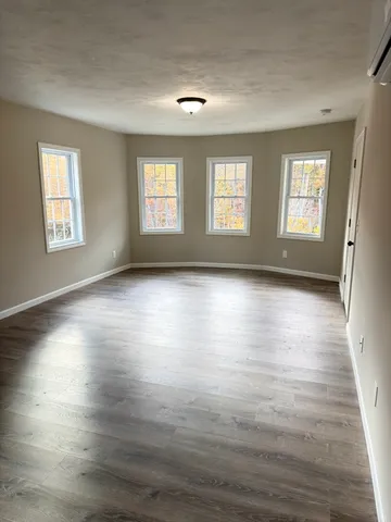 a view of room with window and hardwood floor