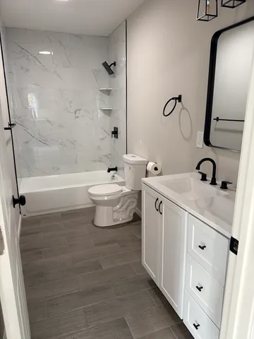a bathroom with a double vanity sink toilet and shower