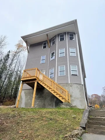 a view of a house with a small yard