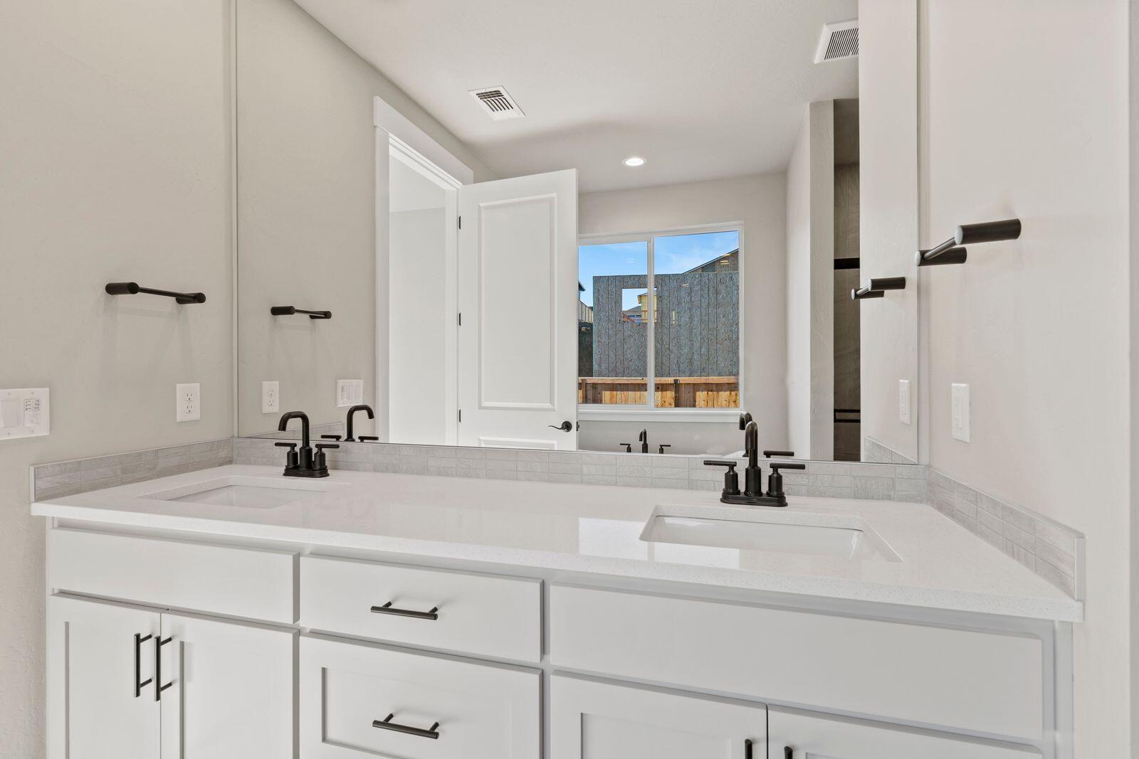 1135 Pumpkin Ridge, Unit 319 Eagle Point, OR 97524 - Photo 17 of 34 a bathroom with a sink and a mirror