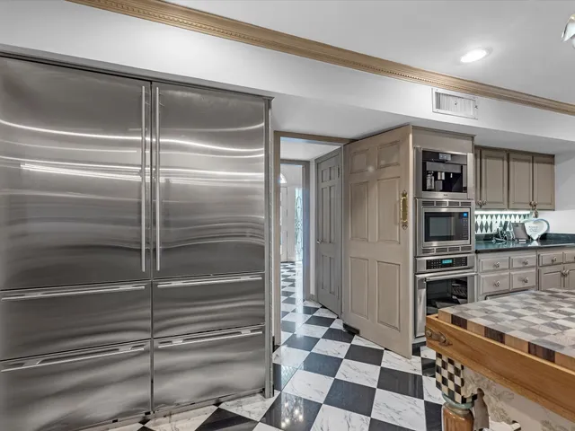 a kitchen with stainless steel appliances and cabinets