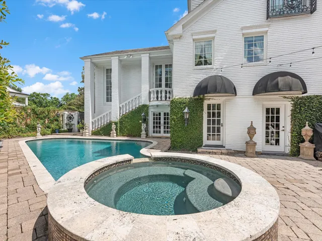 a view of a house with swimming pool and porch