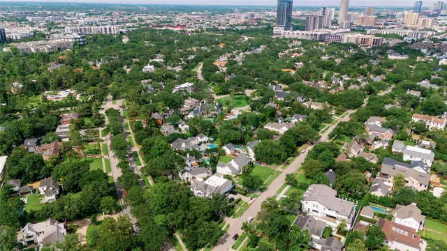 an aerial view of residential houses with city view