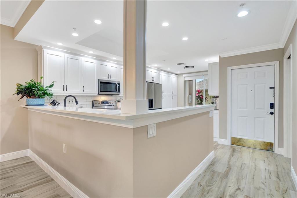 8630 Cedar Hammock Circle, Unit 1012 Naples, FL 34112 - Photo 12 of 37 a bathroom with a sink and a mirror