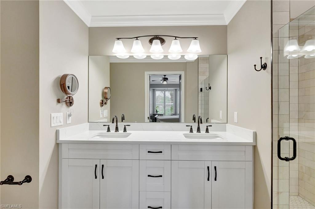 8630 Cedar Hammock Circle, Unit 1012 Naples, FL 34112 - Photo 20 of 37 a bathroom with a sink vanity and a mirror
