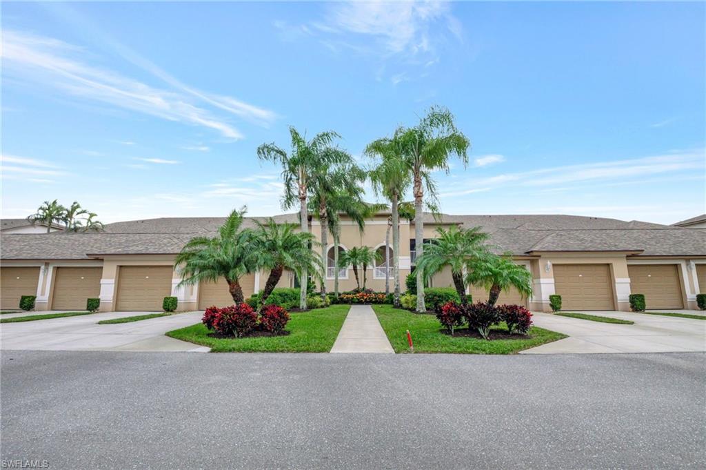 8630 Cedar Hammock Circle, Unit 1012 Naples, FL 34112 - Photo 2 of 37 a palm tree sitting in front of a house with a yard