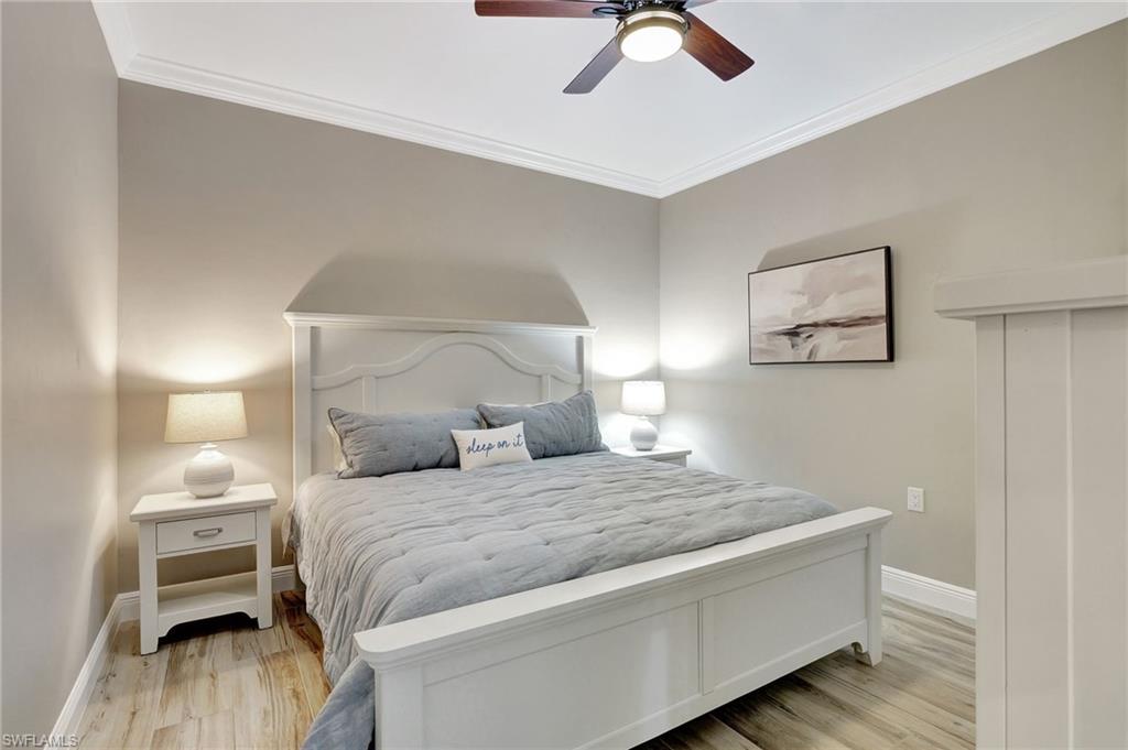 8630 Cedar Hammock Circle, Unit 1012 Naples, FL 34112 - Photo 22 of 37 a bedroom with a bed and painting on the wall