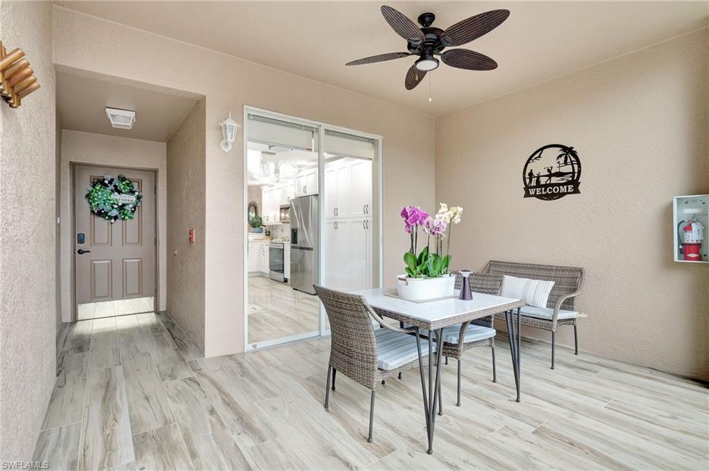 8630 Cedar Hammock Circle, Unit 1012 Naples, FL 34112 - Photo 3 of 37 a view of a dining room with furniture and wooden floor