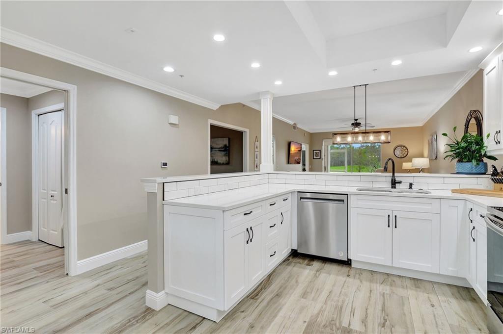 8630 Cedar Hammock Circle, Unit 1012 Naples, FL 34112 - Photo 7 of 37 a large white kitchen with a large window
