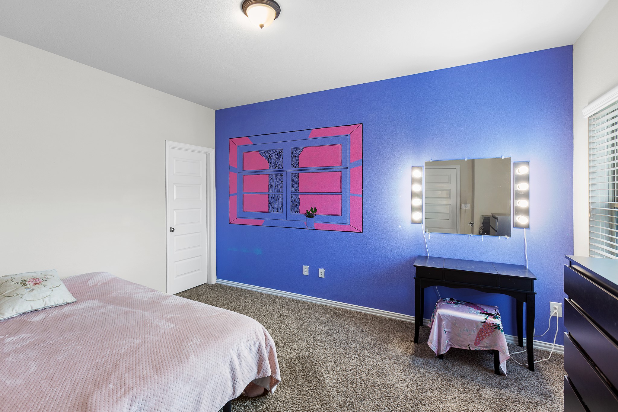 8709 Slater Drive Austin, TX 78747 - Photo 26 of 36 a bedroom with a bed and a fireplace