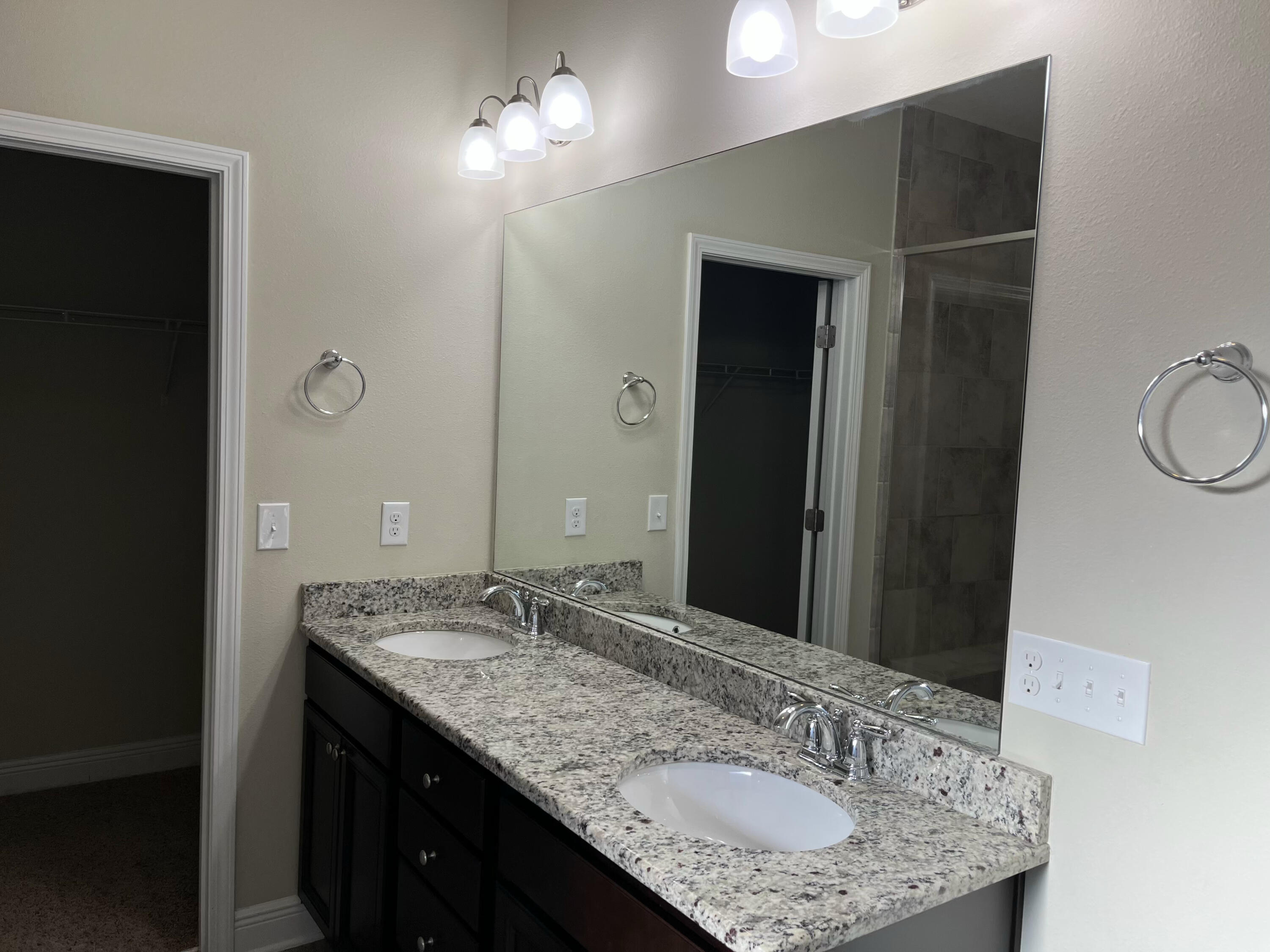 671 Teal Street Crestview, FL 32539 - Photo 15 of 22 a bathroom with a granite countertop sink a mirror and a vanity