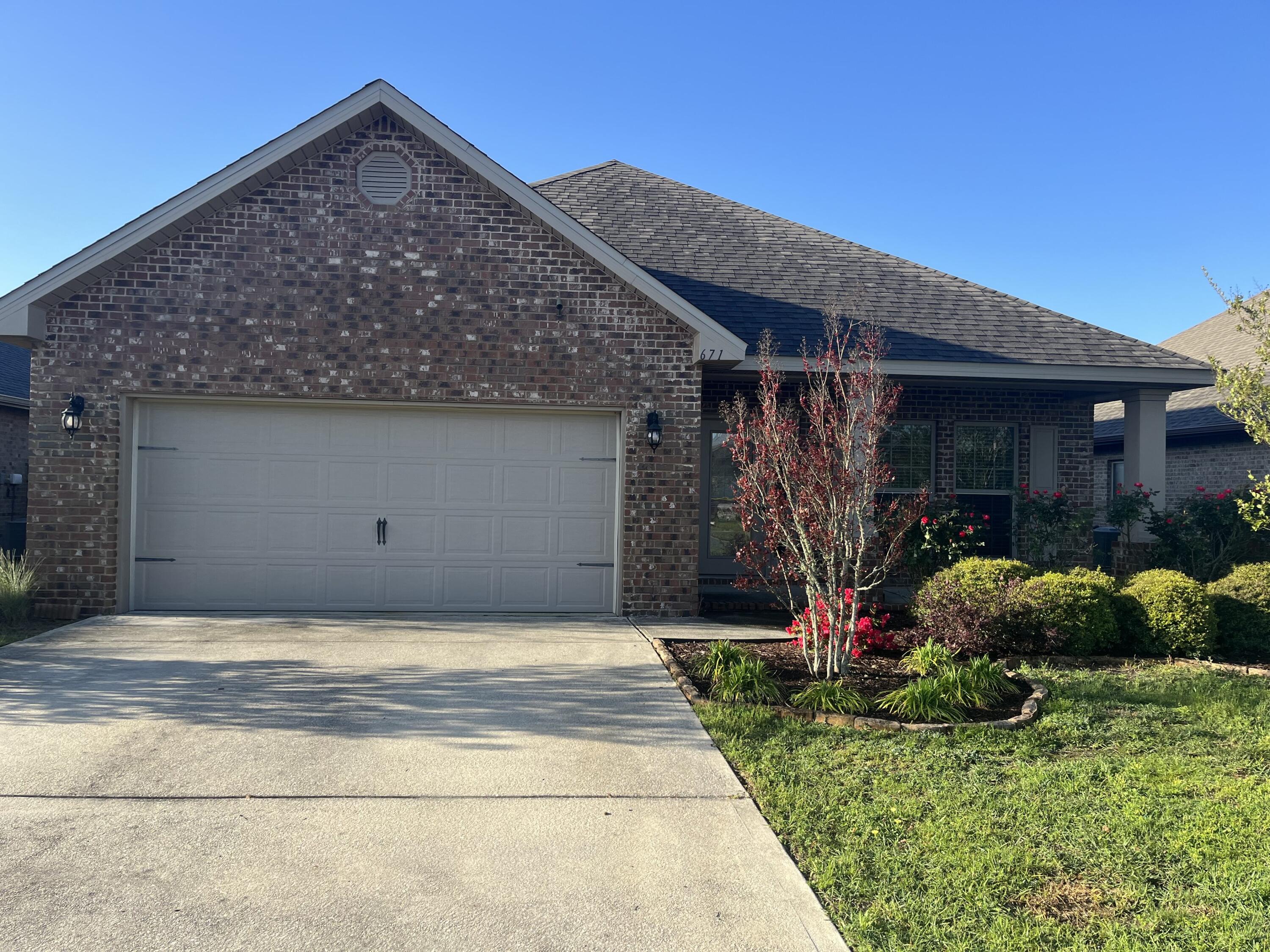 671 Teal Street Crestview, FL 32539 - Photo 2 of 22 a front view of house with garden