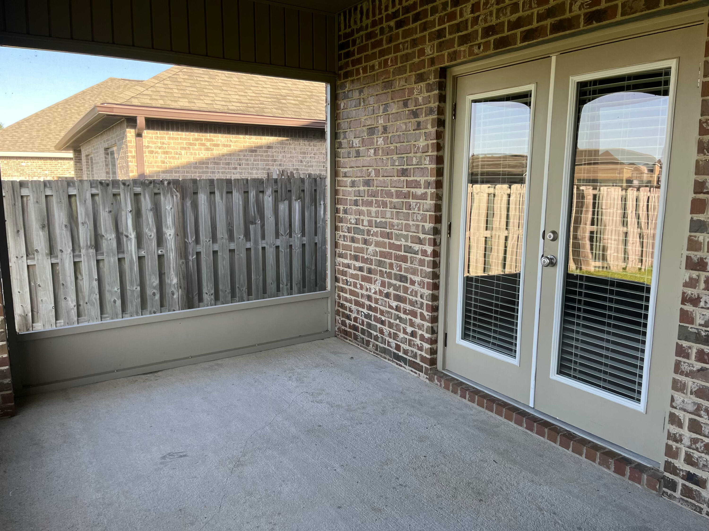 671 Teal Street Crestview, FL 32539 - Photo 21 of 22 a view of a porch with wooden floor and a gate