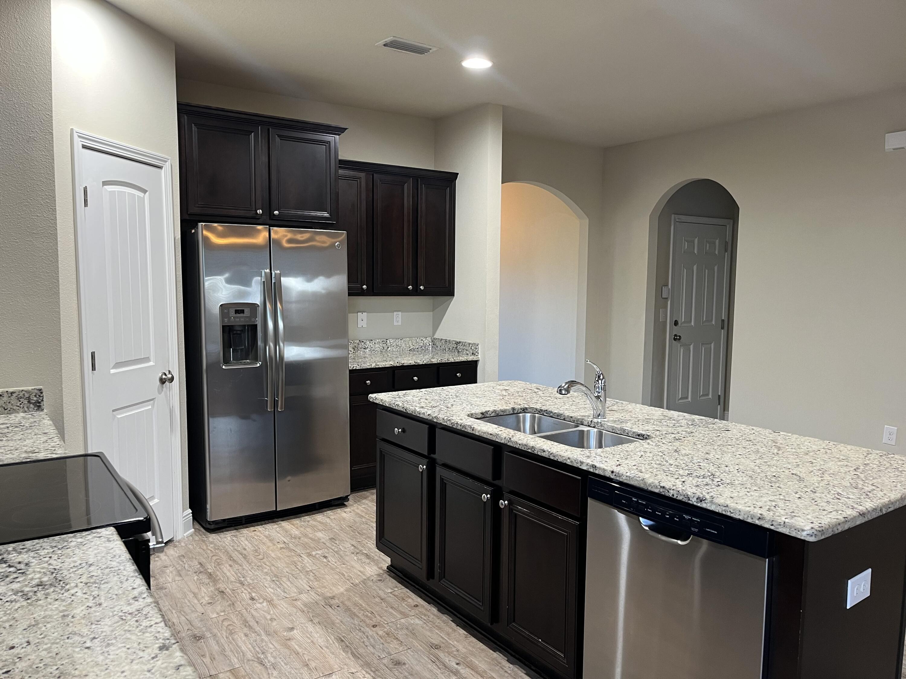 671 Teal Street Crestview, FL 32539 - Photo 8 of 22 a kitchen with stainless steel appliances granite countertop a refrigerator a sink and a stove
