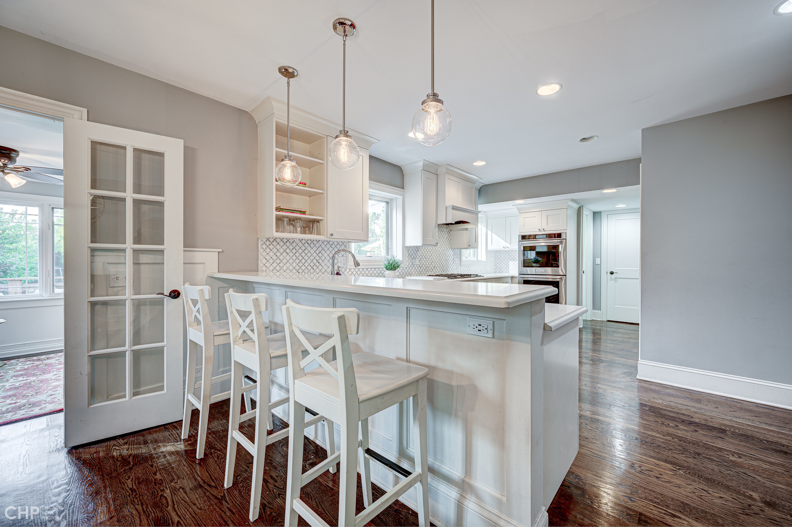 359 Blythe Road Riverside, IL 60546 - Photo 10 of 33 a kitchen with stainless steel appliances kitchen island granite countertop a table chairs and a refrigerator