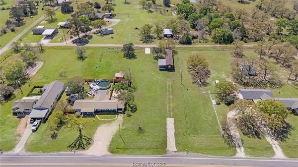 an aerial view of a house with a yard