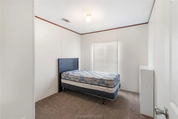 a room with a bed and a mirror