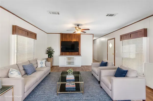 a living room with furniture and a flat screen tv