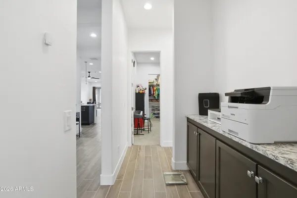 a view of a hallway with wooden floor