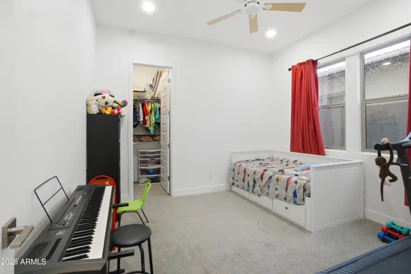 a bedroom with a bed and a ceiling fan