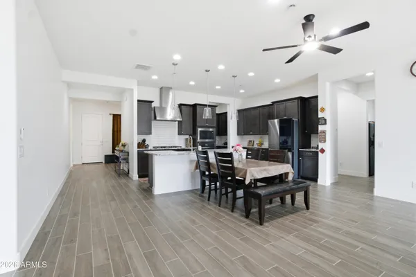 a kitchen with a table chairs refrigerator and cabinets