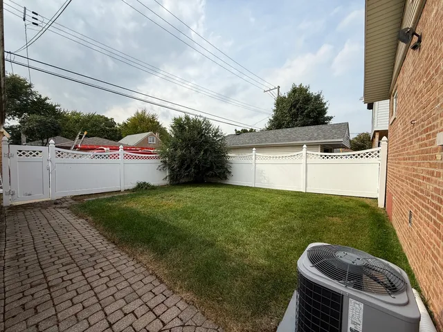 a view of a backyard with sitting area