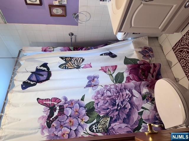 266 Hamilton Road Teaneck, NJ 07666 - Photo 15 of 27 a bathroom with a sink toilet and shower curtain